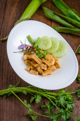 Fried dry buffalo skin on wooden table, Thai food, Laos food.