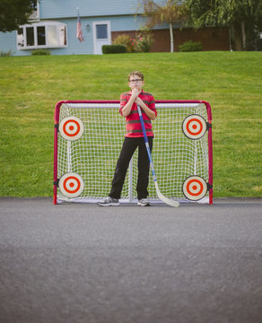 Portrait of Boy Playing Street Hockey