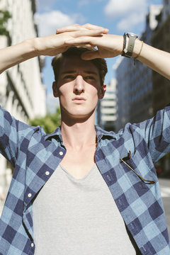 Chiseled hunk shading his eyes from the bright sun