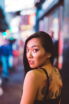 Asian woman with a tattoo on the back