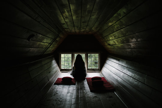 Silhouette of woman in wooden meditation room