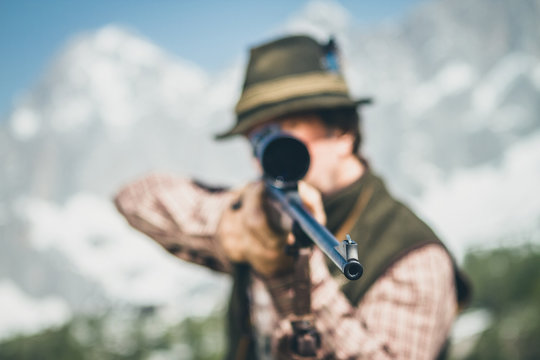portrait of a hunter aiming focused on the gun barrel
