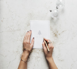 Woman Writing on a Christmas Card