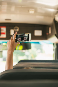 School Bus Girl Holds Up Phone To Take Selfie