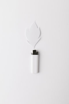 White lighter and a paper flame
