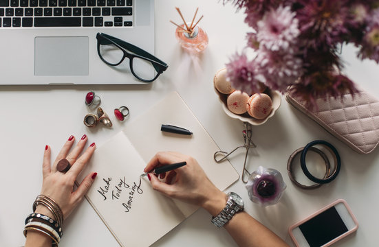 Woman Writing an Inspirational Message in Her Notebook