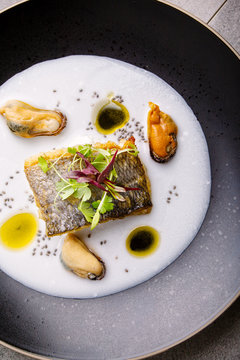 Sea bream with mussel and coconut broth Overhead shot of a fine dining fish course