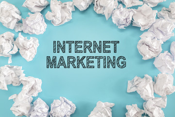 Internet Marketing text with crumpled paper balls