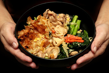 Fried big noodle topped mixed vegetables for organic food.