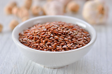 Flax seeds in bowl on table