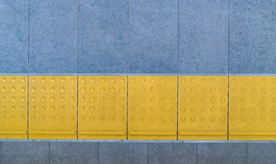 Tactile paving for blind handicap on tiles footpath.