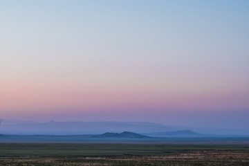 panoramic view of snow-capped mountain ranges at dusk
