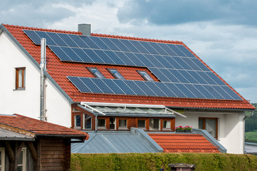 House with solar panels on roof - regenerative energy system electricity generation