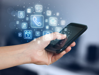 Hand holding smartphone with mobile app icons
