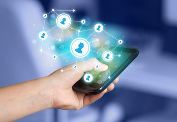 Finger pointing on smartphone, social network concept