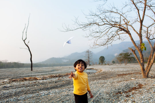 Child playing with paper plane