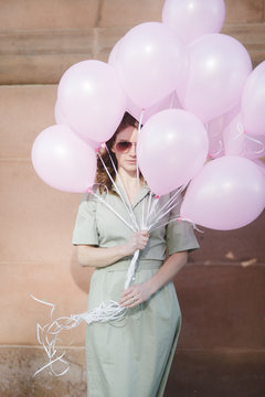 The girl with pink balloons