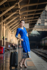 Beautiful Thai girl in Thai costume,Asian woman wearing traditional Thai culture at train station,Bangkok.