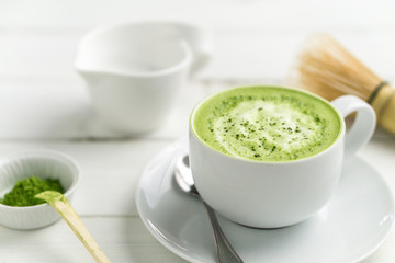 Matcha latte cup close up background blurred. This latte is a delicious way to enjoy the energy boost & healthy benefits of matcha. Matcha is a powder of green tea leaves packed with antioxidants.