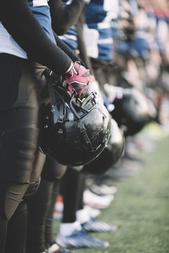 Football team standing with helmets