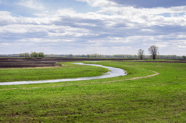 Spring field with puddles of melted water / Photographed in Russia, in the Orenburg region in Saraktashsky District