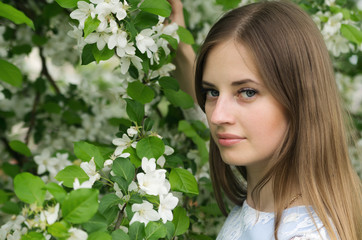Naklejka premium Girl posing against a background of flowering trees / Photographed in Russia, in the city of Orenburg