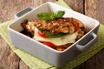 Balsamic chicken stuffed with caprese close-up in a baking dish. horizontal