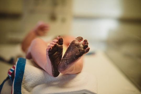 Newborn getting footprint in delivery room