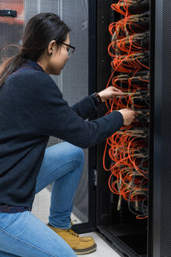 Female engineer working on server in data center