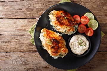 Baked chicken breast stuffed with cheese and spinach, close-up. Horizontal top view