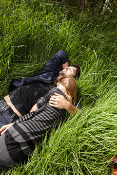 Couple embracing in the grass in nature in California 