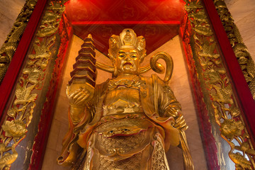 Fototapeta premium The Chinese golden goddess statue at Wat Borom Raja Kanjanapisek Wat Leng Nei Yee 2 Temple, People go to temple to pray for good luck and success in life.