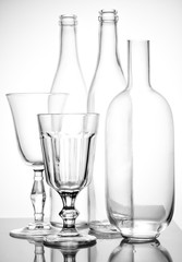 Still life of glass bottles and glasses.