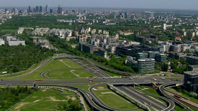 Aerial view over road junction and Warsaw panorama, Poland