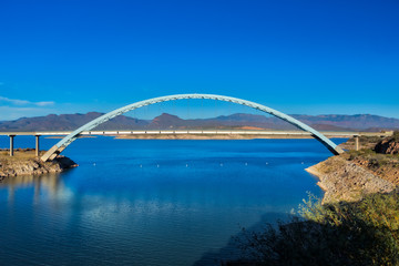 Fototapeta na wymiar Bridge Crossing Lake in Desert