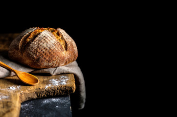Fresh homemade bread on dark table.