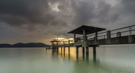Golden light at Jetty with long exposure and dramatic clouds