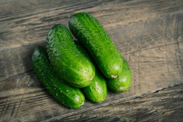 Cucumbers on wooden background