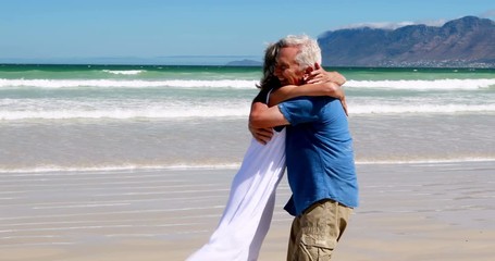 Senior couple enjoying together at the beach - Powered by Adobe