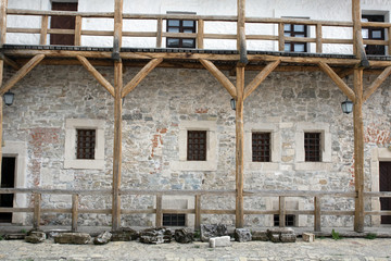 Fototapeta na wymiar medieval castle yard, old wooden balcony, woden stairs