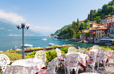 restaurant terrace with view of beautiful Varenna old town, Lake Como, Italy © lukaszimilena