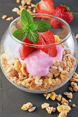 Healthy breakfast. Homemade granola and yogurt with fresh strawberry and mint in glass