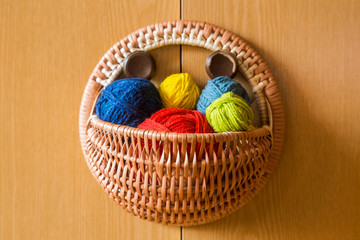 A beautiful, colorful yarn balls in a handmade basket
