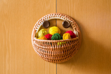 A beautiful, colorful yarn balls in a handmade basket