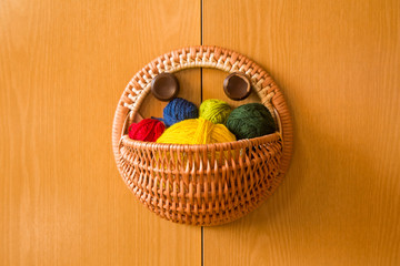 A beautiful, colorful yarn balls in a handmade basket