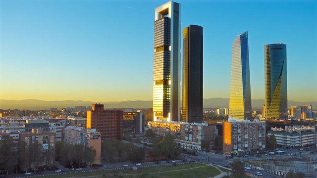 establishing shot of madrid skyscrapers at sunset