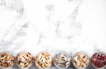 Fototapeta na wymiar Different nuts in jars