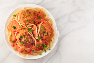 Meatballs and pasta dish, closeup from above with copyspace