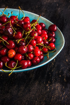 Sweet cherries on dark wooden table