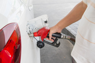 Fototapeta premium man refuel his white car